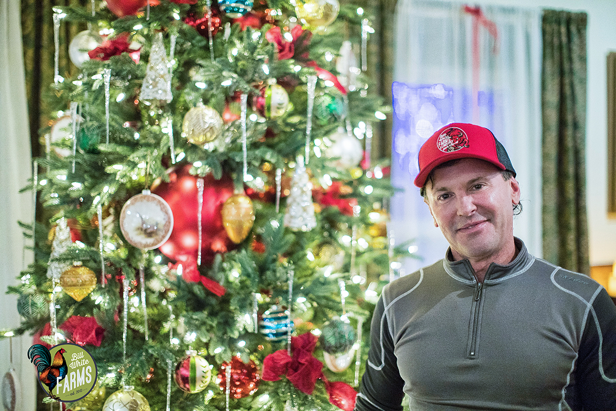 Bill White stands next to the Farms' Christmas tree.&nbsp;